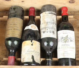 A bottle of 1973 Chateau Norton Grand Vin de Margaux, a bottle of 1973 Chateau Le Bacass Grand Vin de Pauillac red wine (label loose), a bottle of 1974 Chateau Lafon Roche red wine and a bottle of 1974 Chateau Santenay red wine (label damaged)