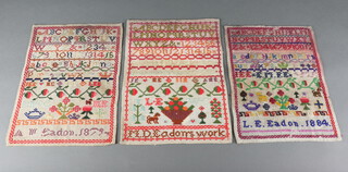 Two Victorian wool work samplers with alphabet and numbers by A M Eadon 1879 and L E Eadon 1874 and 1 other by M D Eadon, all unframed 35cm x 26cm 