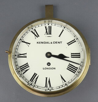 A ward room style clock, the 20cm dial painted roman numerals marked Kendall and Dent London, Swiss escapement, contained in a gilt metal case 23cm diam. 

