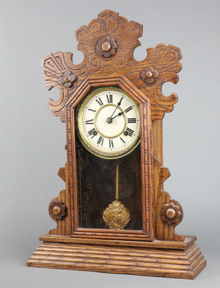 An American 19th Century shelf clock with 13cm painted dial, Roman numerals, contained in a carved oak case complete with pendulum and key 56cm x 38cm x 11cm 