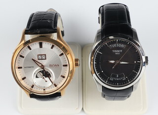 A gentleman's Tissot steel cased day/date automatic wristwatch contained in a 40mm case numbered T035407A together with a gentleman's gilt cased Boss calendar moon phase wristwatch with automatic movement contained in a 45mm case boxed 