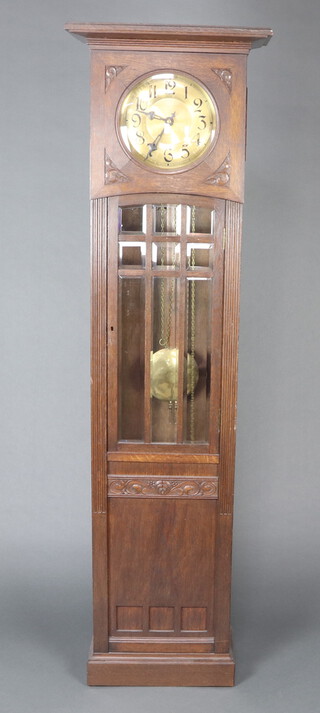 Echo Gong, an Edwardian Art Nouveau 8 day striking on gong long case clock, the 24cm dial with Roman numerals in a carved oak case enclosed by a bevelled glazed panelled door 194cm h 