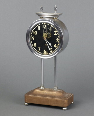A Gravity clock contained in a nickel case, the glass dial with Arabic numerals, case marked Pat.15238-19 24cm h x 12cm w x 7cm d 