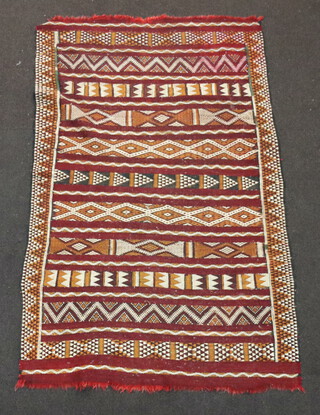 A black, tan and white ground Kilim rug with geometric designs 161cm x 101cm 