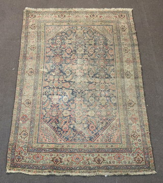 A blue and green ground Persian rug with central floral panel within a multi row border 194cm x 126cm