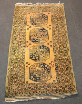 An orange and black ground Afghan rug with 4 octagons to the centre 214cm x 119cm 