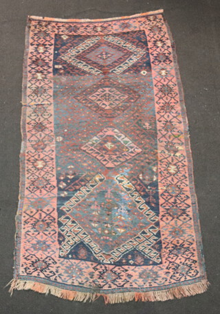 A blue and red Afghan rug with 4 diamonds to the centre 188cm x 103cm 