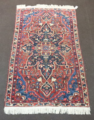A blue, white and red ground Persian rug with central medallion 201cm x 117cm 