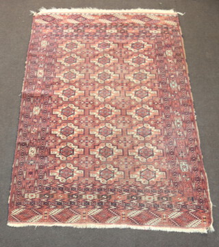 A red and white Bokhara rug with 24 medallions to the centre 208cm x 147cm 