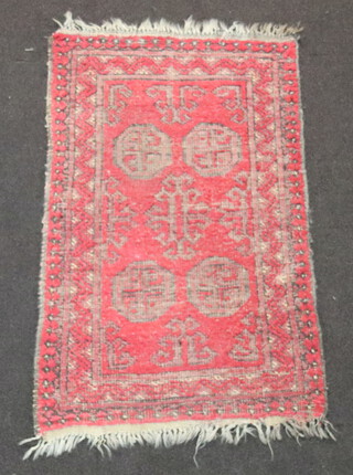 A red and blue ground Afghan rug with 4 octagons to the centre 107cm x 68cm 