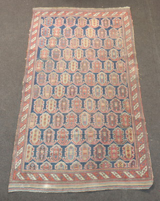 A 19th/20th Century Persian blue and tan ground rug with all over Boteh-Mir design 221cm x 125cm 
