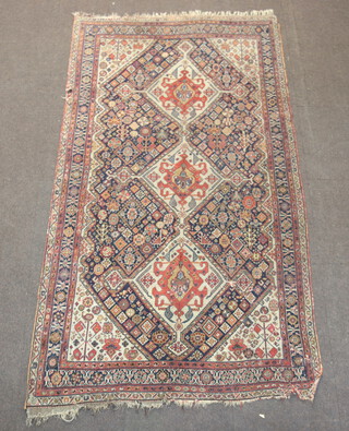 A blue, white and orange ground Persian rug with 3 diamond medallions to the centre 244cm x 135cm 