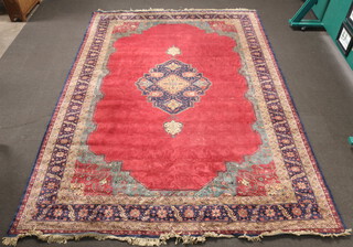 A red, blue and green ground Persian carpet with central medallion within a multi row border 487cm x 336cm  