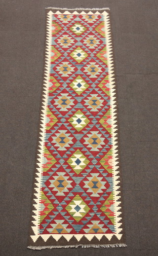 A tan, blue and green ground Maimana Kilim runner with all over diamond design 286cm x 79cm 