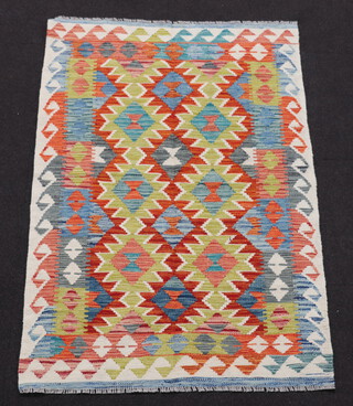 A tan, turquoise and green ground Chobi Kilim with overall geometric design 150cm x 100cm 