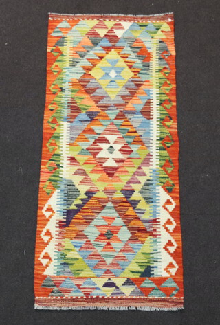 A turquoise, green and orange ground Chobi Kilim runner 142cm x 60cm  