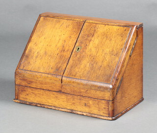 An Edwardian light oak wedge shaped stationery box with stepped fitted interior enclosed by  panelled doors 28cm h x 40cm w x 23cm d  