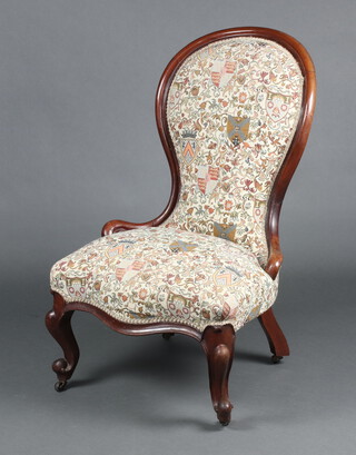A Victorian mahogany show frame nursing chair, the seat of serpentine outline, upholstered in tapestry material, raised on cabriole supports 58cm w x 43cm d 