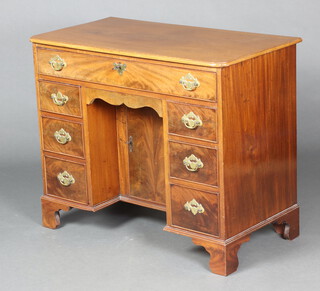 A Georgian mahogany kneehole dressing table fitted a drawer above secret drawer and 6 short drawers, the pedestal fitted a cupboard enclosed by a panelled door, raised on bracket feet 76cm h x 91cm w x 42cm d  