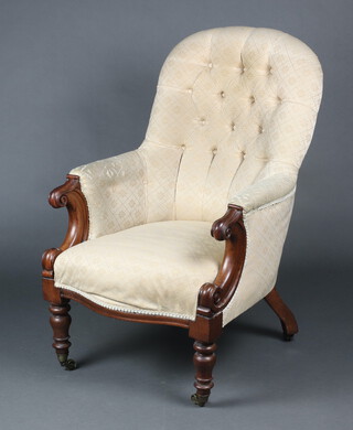 A Victorian mahogany tub back chair upholstered in white buttoned material raised on turned supports with brass casters 99cm h x 67cm w x 56cm (seat 21cm x 34cm) 
