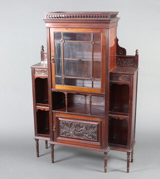 An Edwardian inverted breakfront carved mahogany bookcase, the upper section with pierced gallery, the centre enclosed by astragal glazed panelled door above a recess and cupboard enclosed by glazed panelled doors and flanked by shelved niches 144cm h x 106cm w c 34cm d  