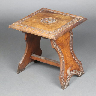 An Eastern carved hardwood square table, the centre with armorial, blind fret work decoration, raised on outswept supports with H framed stretcher 40cm h x 36cm w x 36cm d 