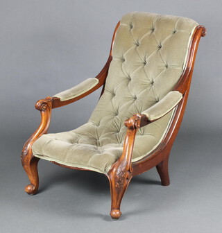 A Victorian carved mahogany show frame armchair upholstered in green buttoned material, raised on cabriole supports 73cm h 