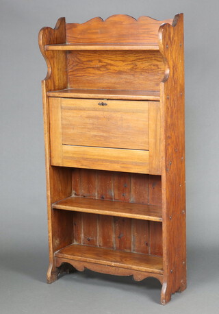 An Edwardian Art Nouveau Liberty style student's bureau with raised back fitted 2 shelves above a fall front revealing a fitted interior and with 2 shelves below 152cm h x 76cm w x 24cm d 