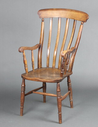 A Victorian elm and beech Windsor stick and bar back kitchen carver chair with solid elm seat, raised on turned supports with H framed stretcher 111cm h x 46cm w x 44cm d (the narrow seat 24cm x 31cm) 