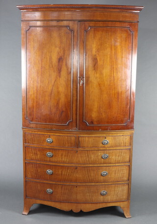 A 19th Century mahogany bow front linen press with moulded and dentil cornice, the interior fitted 2 later shelves enclosed by panelled doors, the base fitted 2 short and 3 long drawers, raised on splayed bracket feet 205cm h x 116cm w x 60cm d 