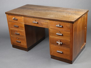 An Art Deco walnut desk fitted 1 long and 8 short drawers, the side fitted a cupboard enclosed by a sliding panelled door 76cm h x 140cm w x 69cm d 