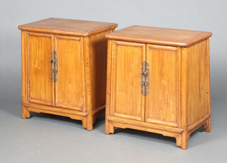 A pair of Chinese rectangular hardwood cabinets, the interiors fitted shelves and 2 drawers, enclosed by panelled doors 61cm h x 53cm w x 35cm d 