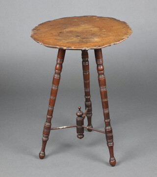 An Edwardian circular mahogany cricket table with pie crust edge, raised on turned supports with Y shaped stretcher 69cm x 50cm diam., the base with Eastern Railway Company label marked Canon Street to Redhill 