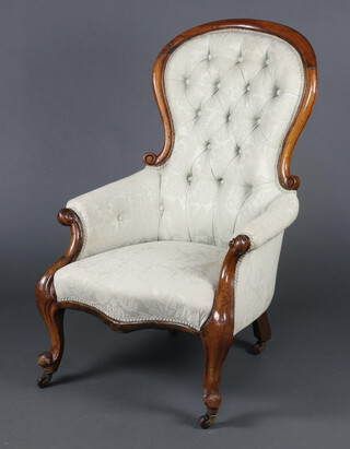 A Victorian mahogany show frame armchair upholstered  in green buttoned material, raised on cabriole supports 109cm h x 69cm w x 60cm d (seat 38cm x 41cm) 