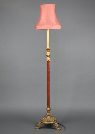 An Italian style carved and painted gilt wood standard lamp raised on a circular base with 3 scroll feet 140cm x 37cm 