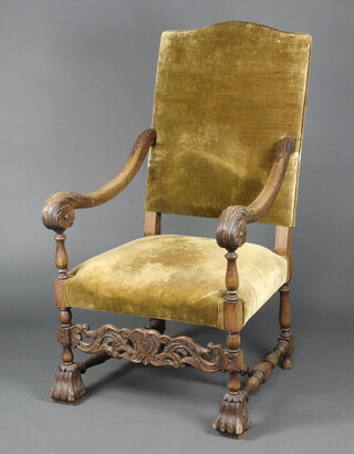 A 17th Century style carved beech open arm chair with upholstered seat and back, carved and pierced apron, raised on scroll supports 121cm h x 66cm w x 63cm d (seat 32cm x 40cm) 
