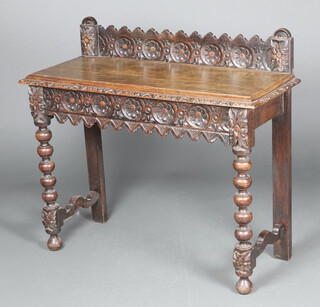 A Victorian carved oak hall table with raised back, fitted a frieze drawer, raised on turned supports 91cm h x 104cm w x 42cm d 