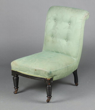 A Victorian nursing chair upholstered in green material, raised on turned supports 76cm h x 49cm w x 53cm d (seat 31cm x 32cm) 