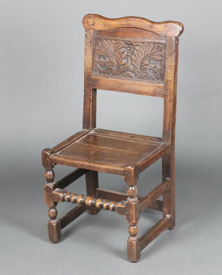 A 17th Century style carved oak hall chair with carved panel to the back, solid seat, raised on turned and block supports 92cm h x 44cm w x 36cm d 