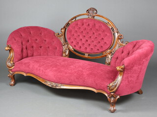 A Victorian carved walnut show frame sofa the back upholstered in red buttoned material raised on cabriole supports 97cm h x 193cm w x 71cm d (seat 145cm x 61cm) 