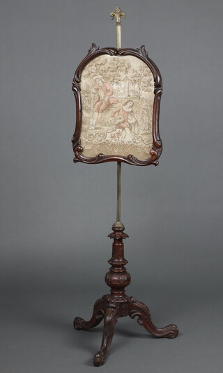 A Victorian pole screen with machine tapestry panel raised on a gilt column and carved walnut tripod base 147cm h x 54cm w