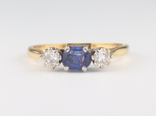 A yellow metal 18ct sapphire and diamond ring, the centre stone approx. 0.5ct, the 2 diamonds each 0.20ct, size N 