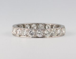 A white metal 21 stone diamond eternity ring, approx. 1ct, 3.4 grams, size P 