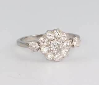 A white metal platinum diamond cluster ring comprising 12 brilliant cut diamonds approx. 1ct, 3.9 grams, size P 