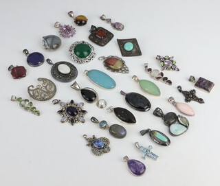 A quantity of silver mounted pendants and brooches