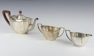 A silver 3 piece tea set with fruitwood mounts, Birmingham 1927 and 1928, Maker Barker Brothers Silver Ltd 1080 grams gross