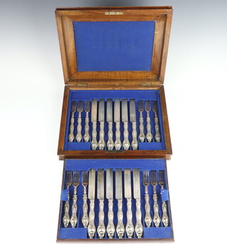 A walnut canteen containing a set of 12 silver dessert knives and forks, London 1867, maker George W Adams 