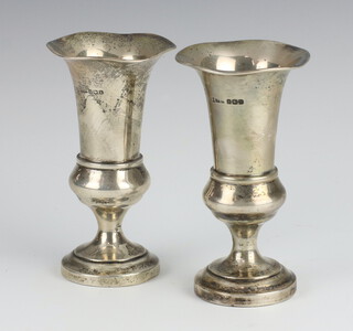 A pair of silver waisted vases 11cm, weighted