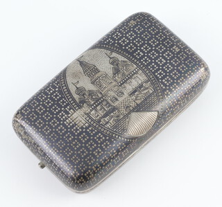 A Russian silver niello rounded rectangular cigarette box decorated with a palace scene and geometric ground, engraved monogram and gilt interior 132 grams, 9cm 