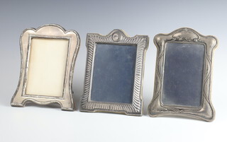 A silver photograph frame Birmingham 1912, 19cm x 14cm, 2 others 